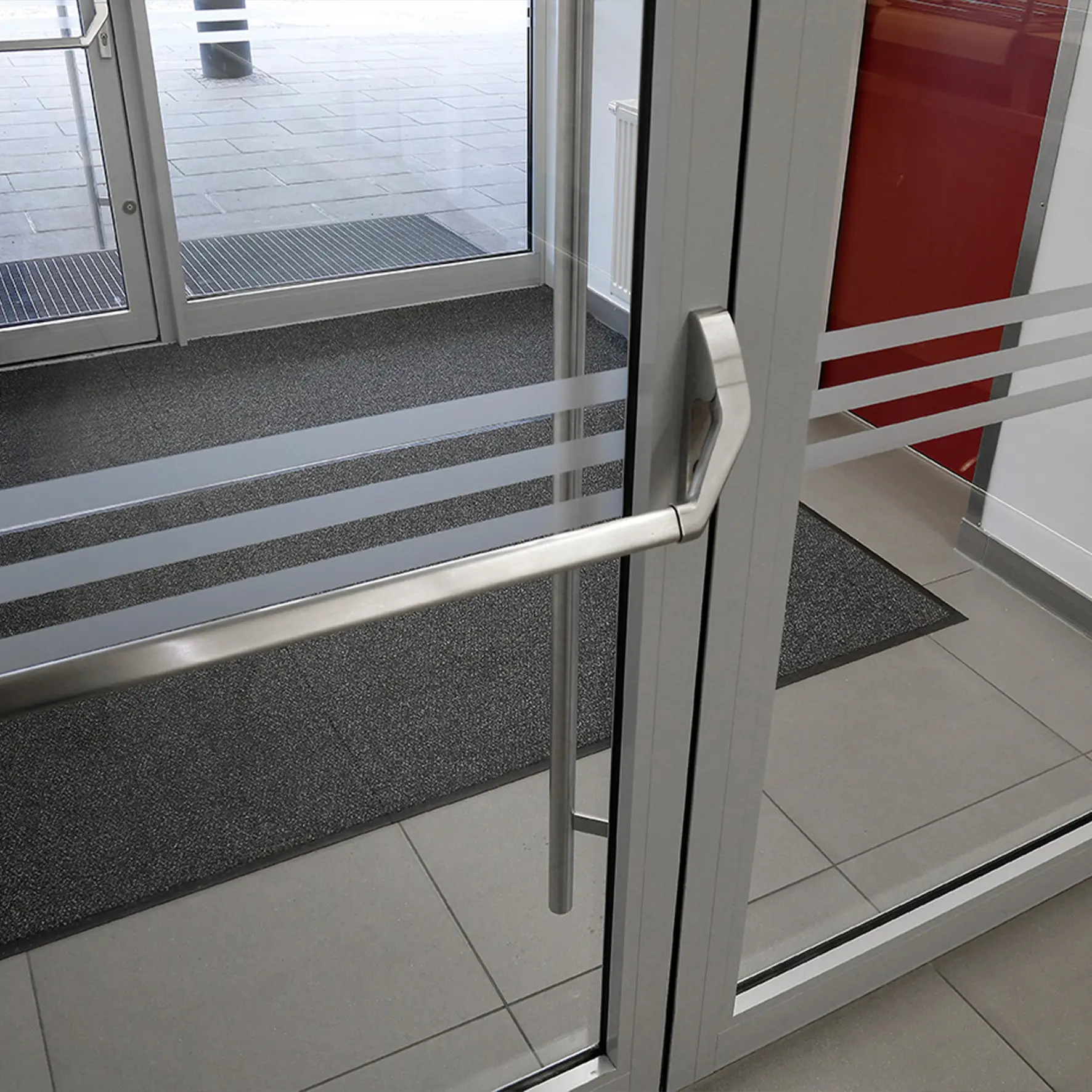 Nahaufnahme einer Anlaufschutzfolie auf Glastür gegen Fingerabdrücke und Stöße